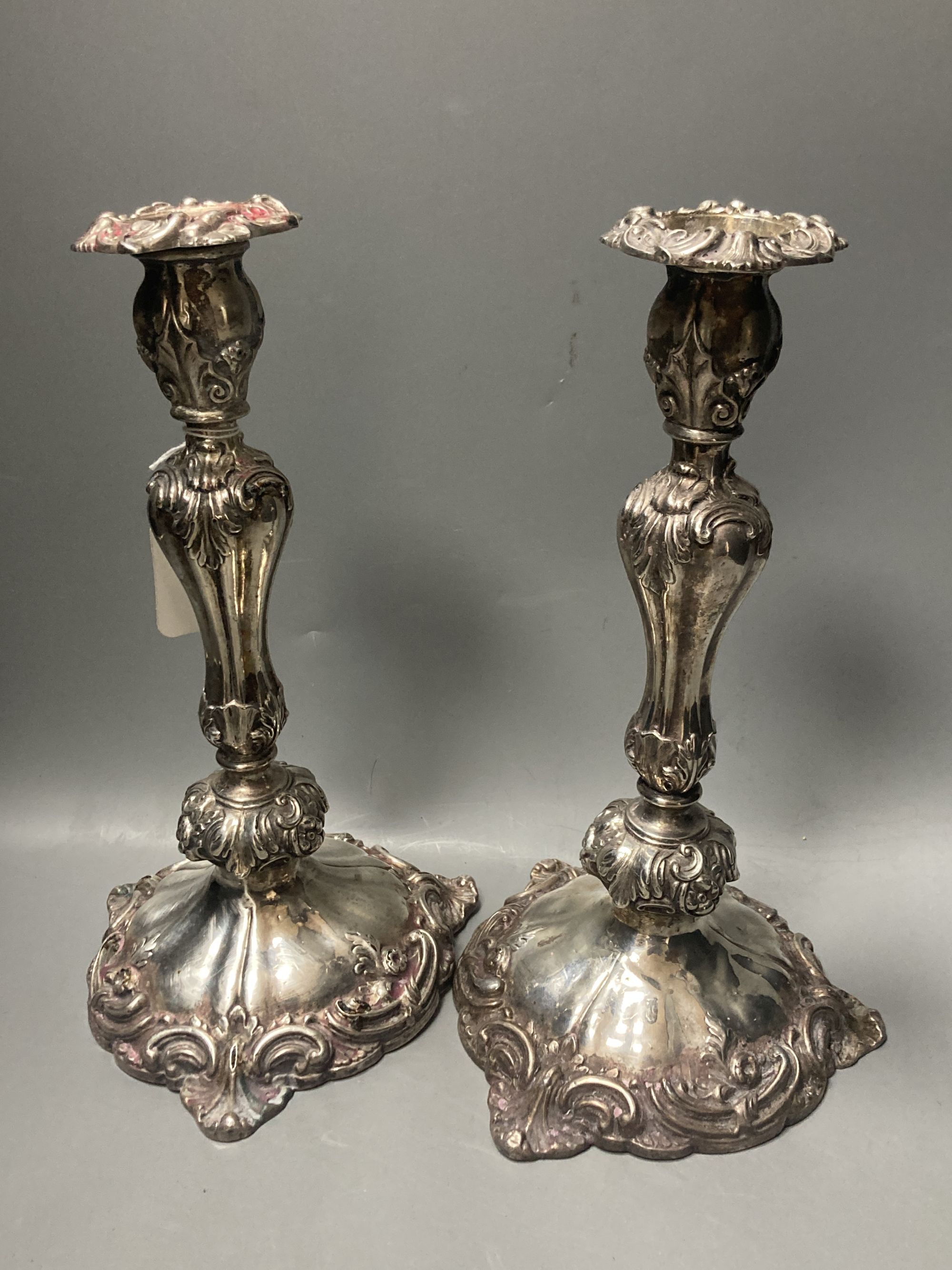 A pair of early Victorian silver candlesticks, indistinct makers mark, Sheffield, 1840, 29cm, weighted (a.f.) & later arms.